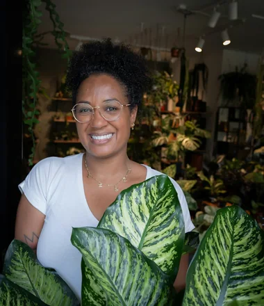 Owner of Leaf and Loam holding a plant